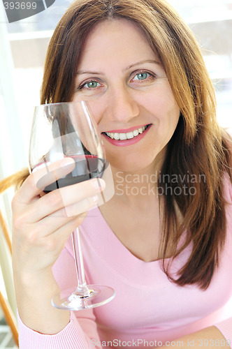Image of Mature woman with a glass of red wine