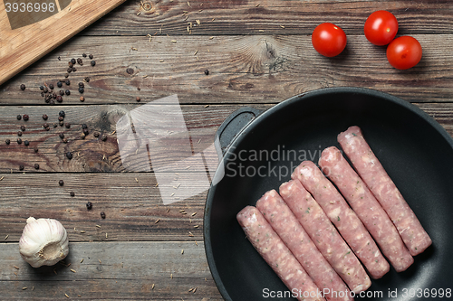 Image of Raw Sausages in a Pan