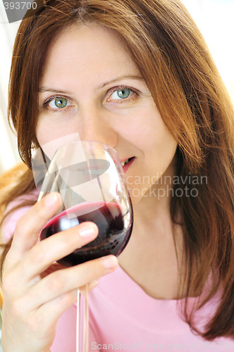 Image of Mature woman with a glass of red wine