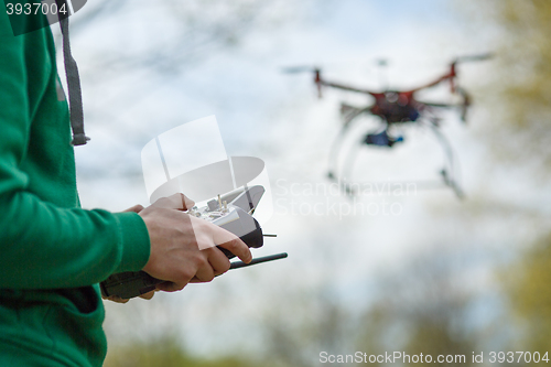 Image of Man controling a drone.