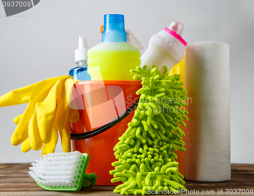 Image of Bucket with cleaning items on light background