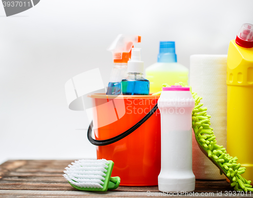 Image of Bucket with cleaning items on light background