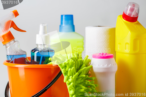 Image of Bucket with cleaning items on light background