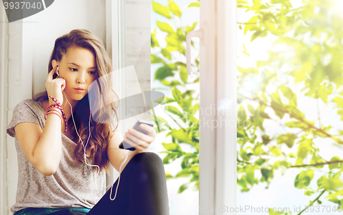 Image of teenage girl with smartphone and earphones