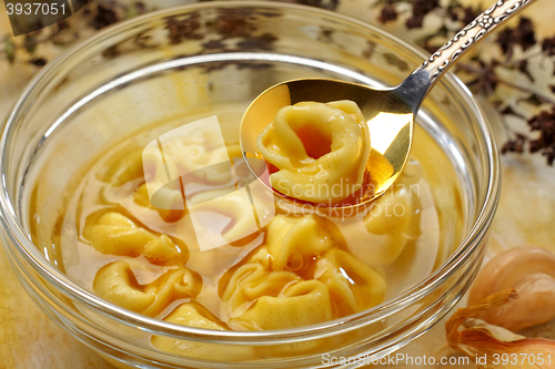 Image of Freshly boiled tortellini in glass bowl with broth