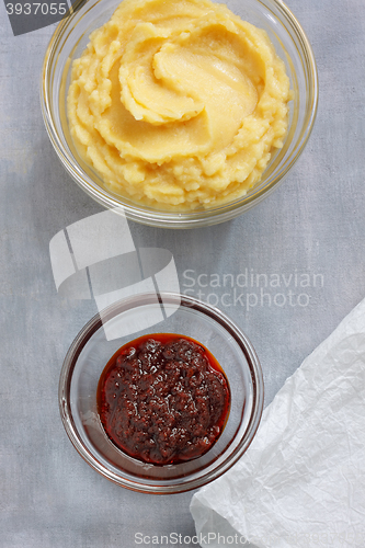 Image of Hummus and harissa sauce on painted textile background