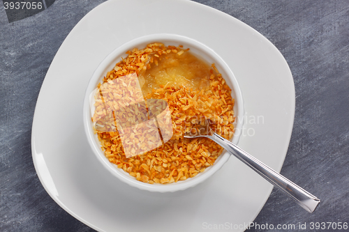 Image of Stuffed apple dessert with grated coconut topping