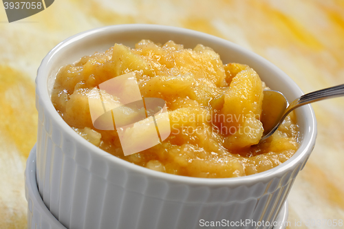 Image of Ramekin filled by chopped and baked apple dessert