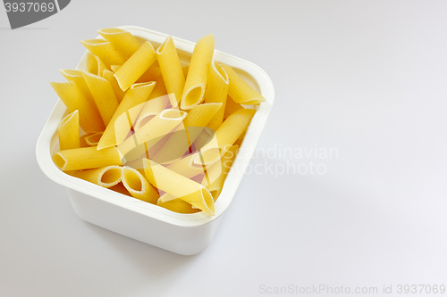 Image of Penne rigate pasta in the plastic box