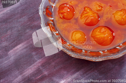 Image of Glass bowl filled by compote made from red mirabelle plum