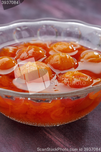 Image of Glass bowl filled by compote made from red mirabelle plum