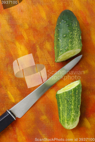 Image of Halved cucumber and knife