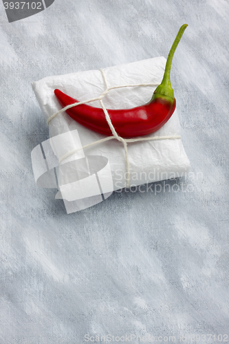 Image of Still life with package and hot chili pepper