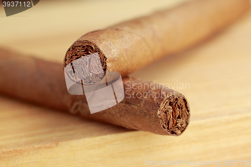 Image of Cigars on wooden board