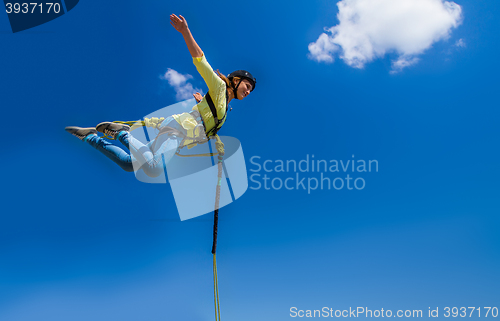 Image of Girl jumping against the sky