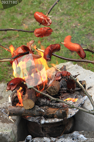 Image of traditional czech sausages and the fire 