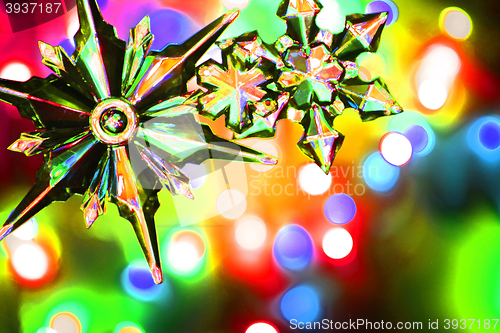Image of snowflake and christmas lights color background