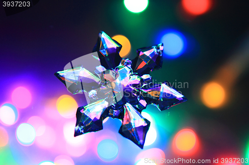 Image of snowflake and christmas lights color background