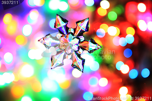 Image of snowflake and christmas lights color background