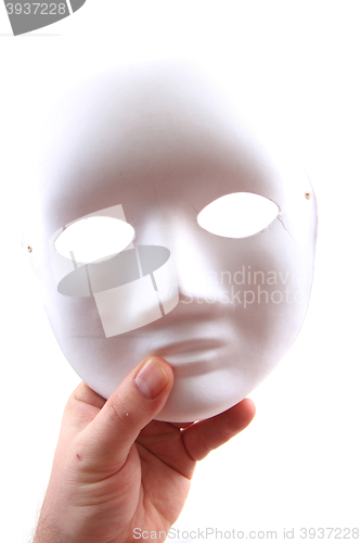 Image of white carnival mask in human hand