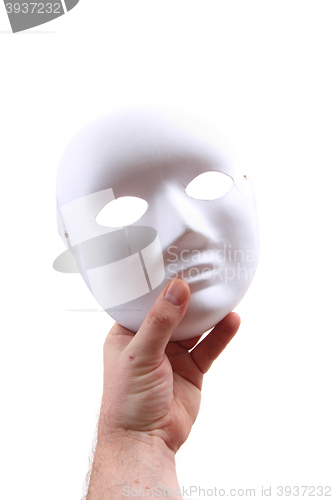 Image of white carnival mask in human hand