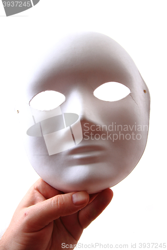 Image of white carnival mask in human hand