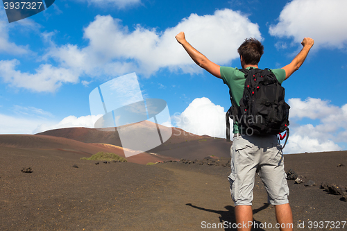 Image of Man reaching the top of mountain.