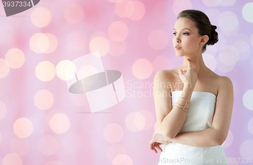 Image of beautiful asian woman with golden bracelet