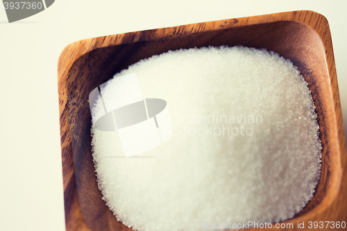 Image of close up of white sugar heap in wooden bowl