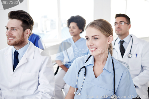 Image of group of happy doctors on seminar at hospital