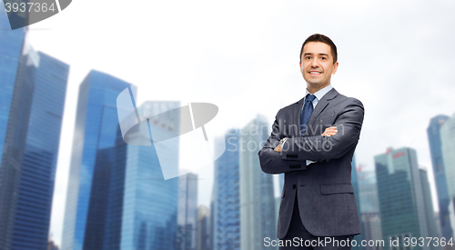 Image of happy smiling businessman over singapore city 