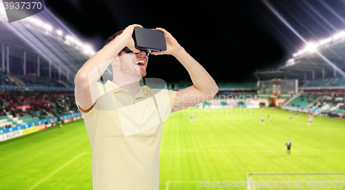 Image of man in virtual reality headset over football field