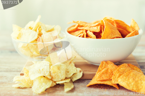 Image of close up of potato crisps and nachos in glass bowl