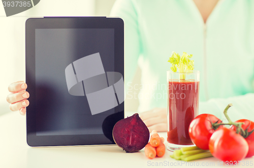 Image of close up of woman with tablet pc and vegetables