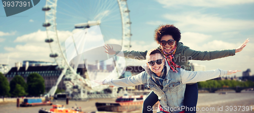 Image of happy teenage couple having fun over london