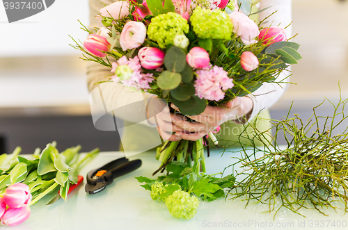 Image of close up of woman making bunch at flower shop