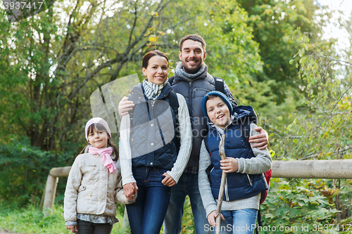 Image of happy family with backpacks hiking