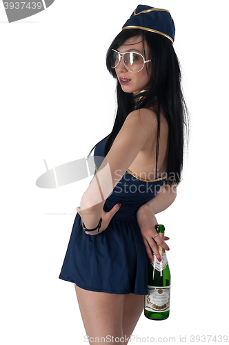 Image of Young beautiful air hostess with wine bottle