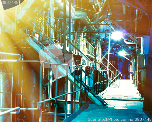 Image of Pipes, tubes, machinery and steam turbine at a power plant