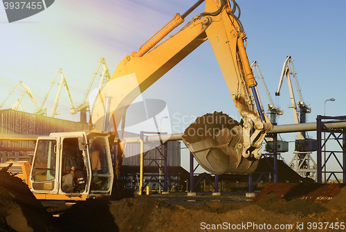 Image of Hydraulic excavator at work. Shovel bucket and cranes against bl