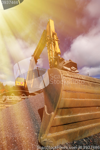 Image of excavator against blue sky