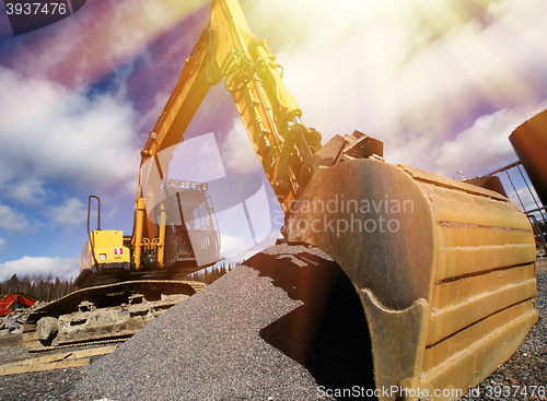 Image of excavator against blue sky