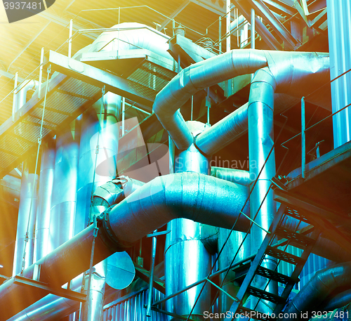 Image of Pipes, tubes, machinery and steam turbine at a power plant