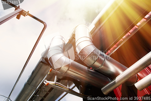 Image of Industrial zone, Steel pipelines and valves against blue sky