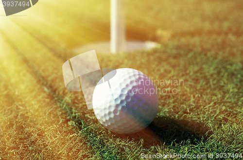 Image of Golfball in front of the hole