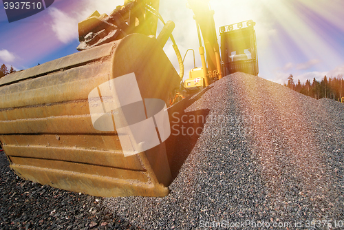 Image of excavator against blue sky