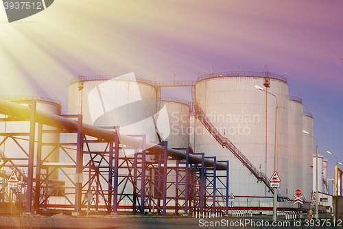 Image of Industrial zone, Steel pipelines and tanks against blue sky