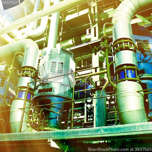 Image of Pipes, tubes, machinery and steam turbine at a power plant