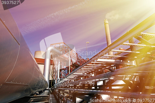 Image of Industrial zone, Steel pipelines and valves against blue sky