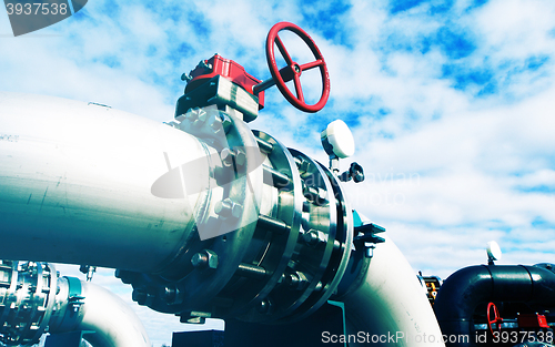 Image of Industrial zone, Steel pipelines and valves against blue sky